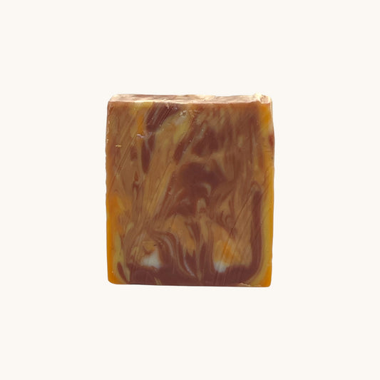 Back view of Memaw’s Citrus Sunrise tallow soap bar showing natural swirls of color.